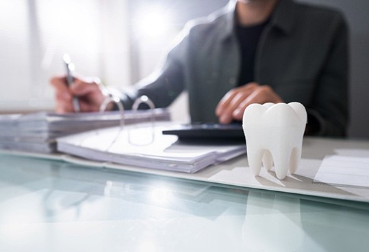 Patient in Farmington Hills reviewing cost of dental crowns