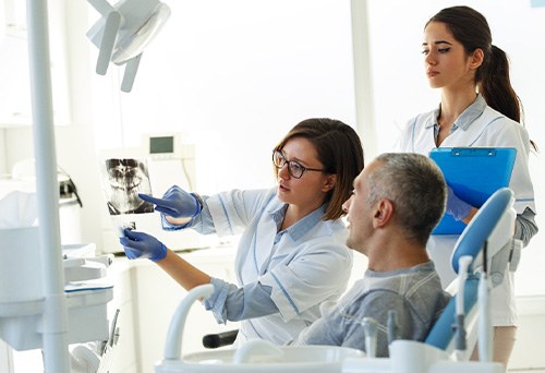 Dentist going over X-rays with patient