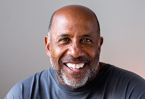 Closeup of senior man in gray shirt smiling