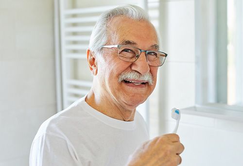Farmington Hills patient smiling before denture cleaning routine
