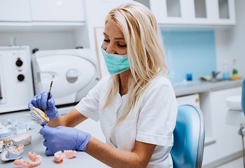 Lab technician adding details to dentures