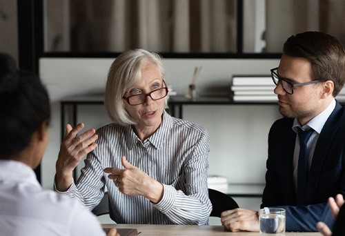 Farmington Hills patient smiling leading team at work