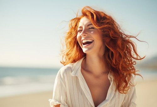 Woman smiling while on the beach