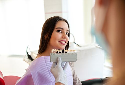 a dentist talking with their patient about smile makeovers