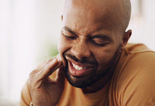 Closeup of patient experiencing jaw pain