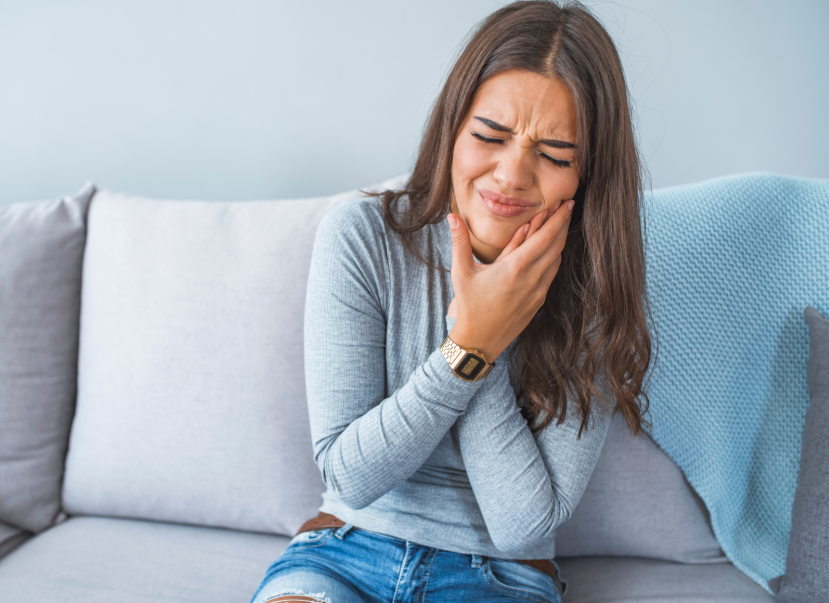 Woman holding jaw in pain